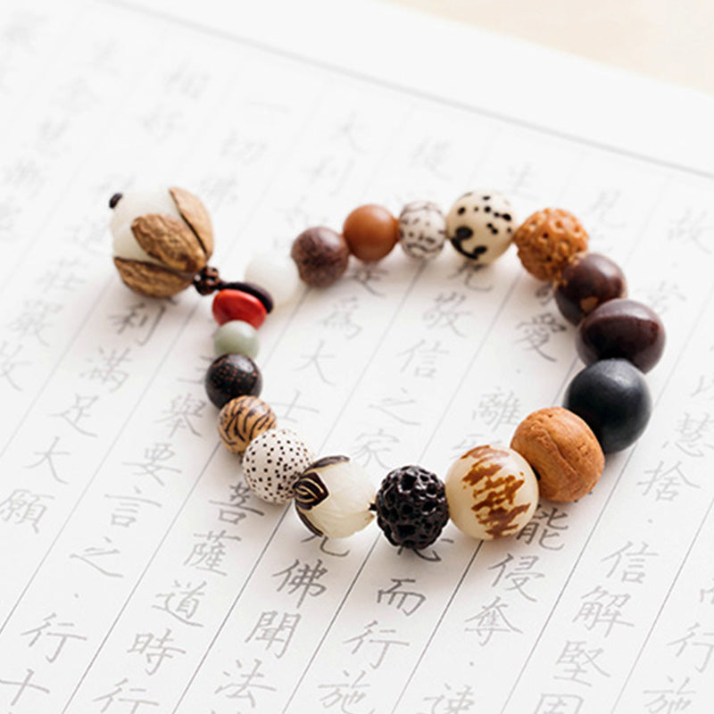 Bodhi Seed Lotus Mala – On sutra paper with lotus dangle charm and red accent, wisdom bracelet