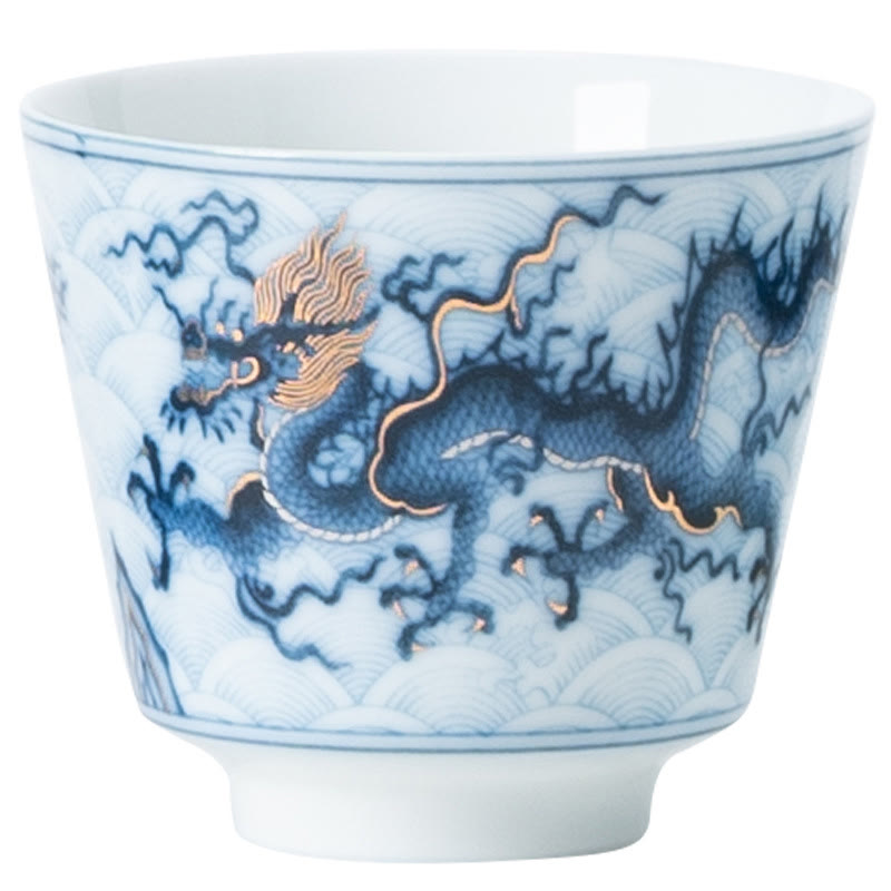 Blue & White Dragon Ceramic Teacup – single cup three-quarter view on white background, gold details, premium