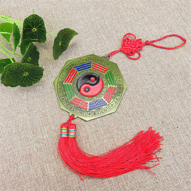 Feng Shui Bagua Map Mirror - Traditional bagua mirror amulet with yin-yang center, red tassel and lucky knot on brass octago.