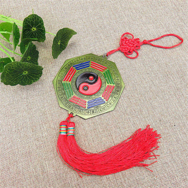 Feng Shui Bagua Map Mirror - Traditional bagua mirror amulet with yin-yang center, red tassel and lucky knot on brass octago.