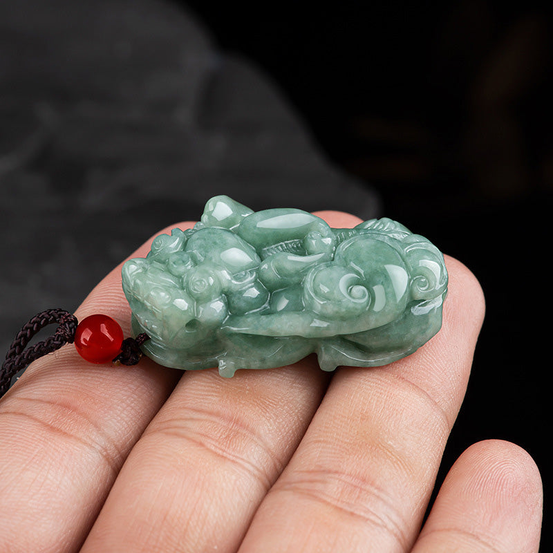 Jade PiXiu Necklace – Pale green jade Pixiu held in palm showing detailed carving, close-up hand