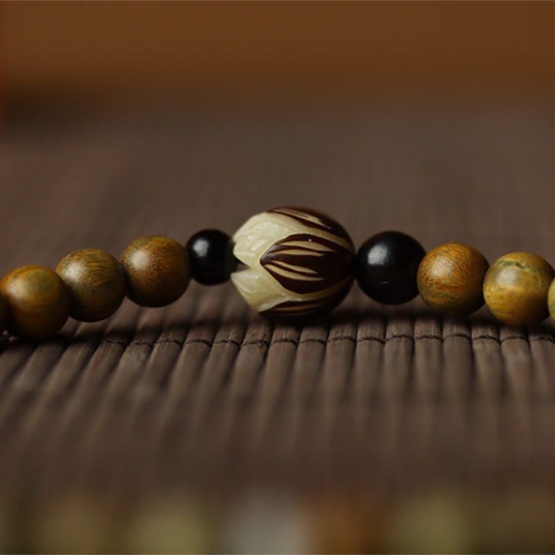Green Sandalwood Lotus Bracelet – extreme macro lotus carving on rattan, onyx bead contrast