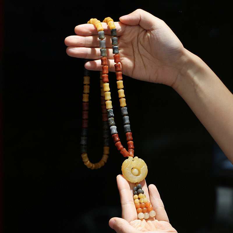 Golden Silk Jade Flower Pendant Necklace – tricolor cylindrical beads yellow red gray with carved spiral pendant, hand display