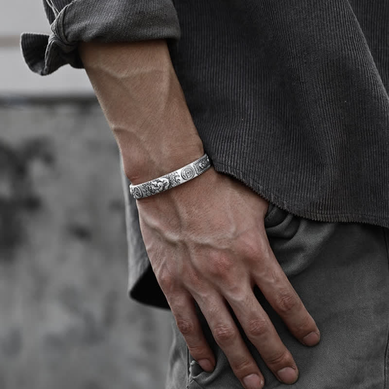 Oxidized silver Pixiu bracelet with intricate engravings on man's wrist, antique finish feng shui wealth protection cuff jewelry
