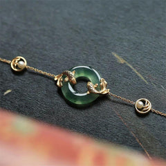 Cyan Jade Koi Bracelet - close-up of koi fish pendant on cyan jade beaded strand