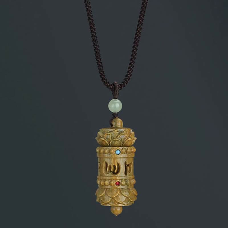 Om Mani Padme Hum Necklace – Golden-brown prayer wheel with lotus crowns, cutout mantra script, jade bead, spiritual
