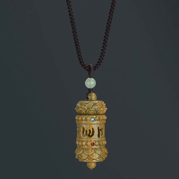 Om Mani Padme Hum Necklace – Golden-brown prayer wheel with lotus crowns, cutout mantra script, jade bead, spiritual
