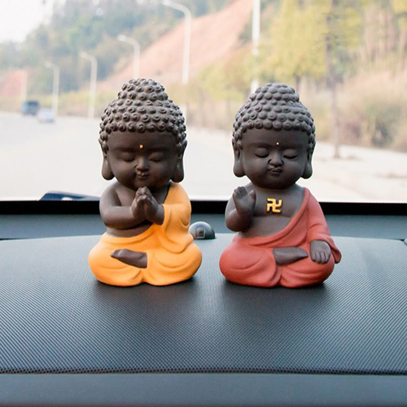 Small Buddha Purple Clay Decoration – paired yellow and red figures on dashboard, frontal eye level, complementary mudras, Pr
