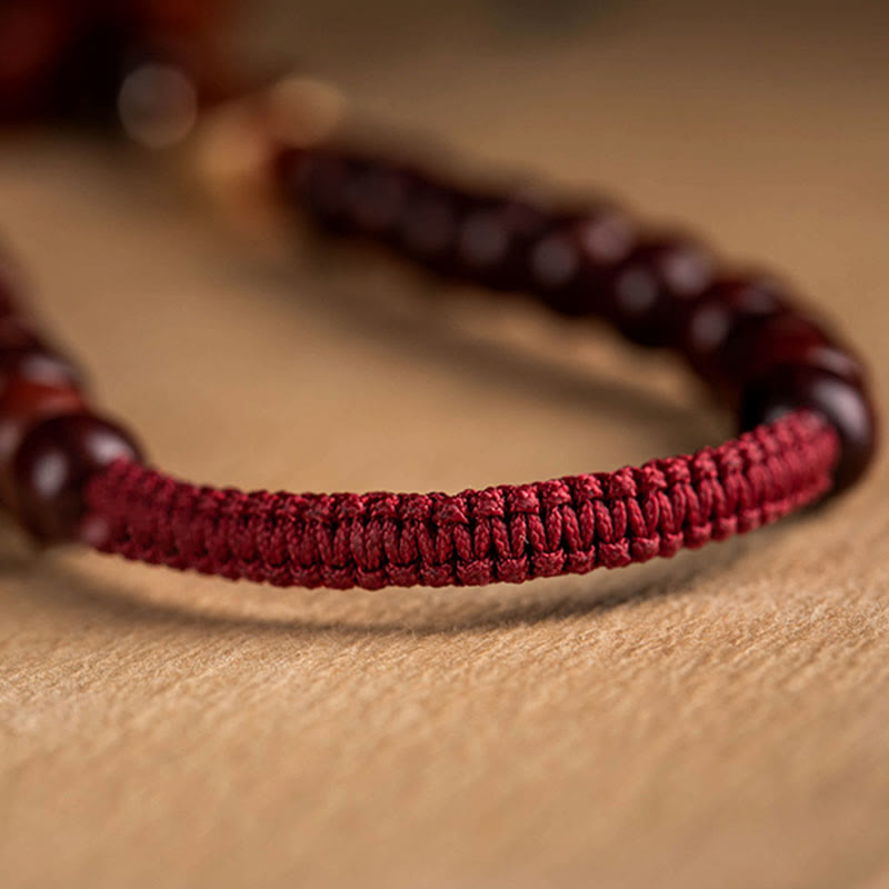 Red Sandalwood Car Hanging – Dual strands with wealth blessing pouch and lotus tassel on sandalwood beads, temple background