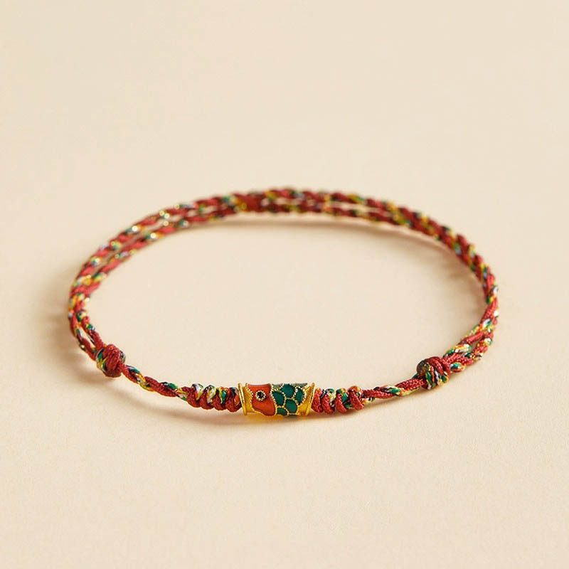 Koi Fish Wealth Bracelet – Close-up of koi fish wealth charm on red string, Feng Shui bracelet