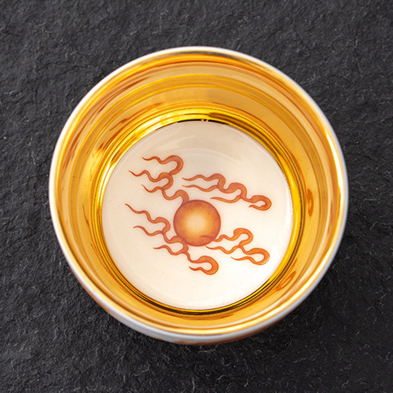 Dragon Phoenix Crane Gilt Ceramic Teacup – close-up iron-red dragon with gold outlining and wave pattern, macro detail, premium
