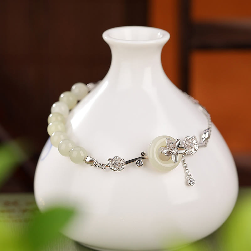Sterling Silver Hetian Jade Peace Buckle Bracelet - silver chain draped on white ceramic vase