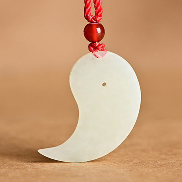 Yin Yang Jade Necklace – On-model shot, white jade crescent pendant on red cord worn with black top