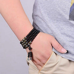 Black Obsidian Mala Bracelet - Worn on wrist with gold mantra beads and traditional knot closure, obsidian wrap bracelet