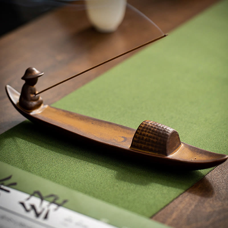 Fisherman Incense Burner – Copper-toned boat figure on green mat with calligraphy, healing zen