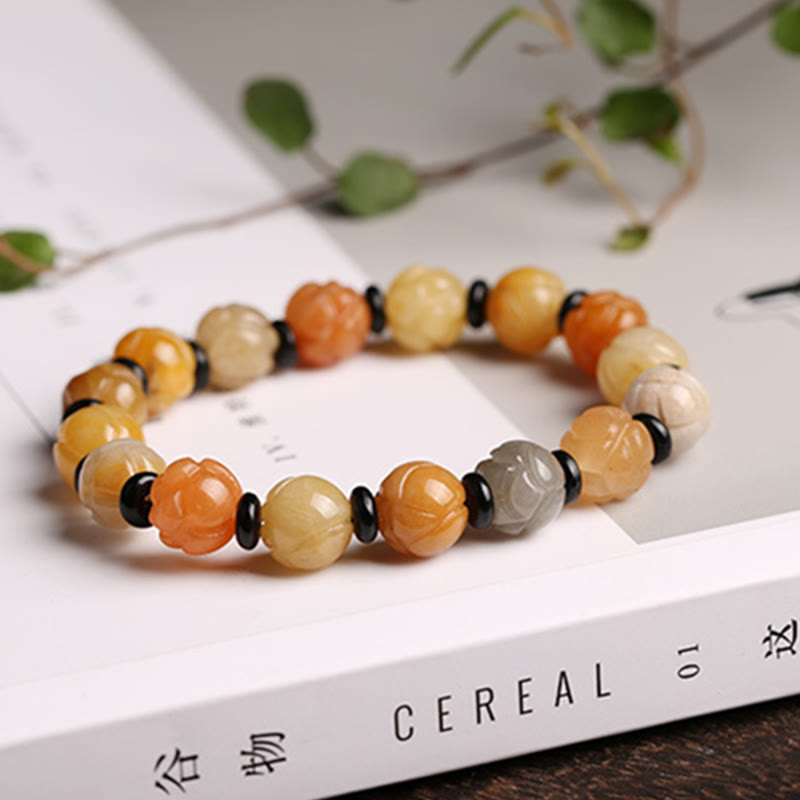 Golden Silk Jade Lotus Bracelet – Lotus carved beads on Cereal magazine with eucalyptus, amber tones, jade lotus