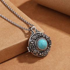Tibetan Pi Xiu Necklace – Silver pendant with turquoise inlay on craft paper surface