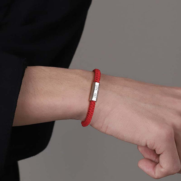 925 Sterling Silver Letter Blessing String Bracelet – Red cord bracelet with silver engraved bar worn on wrist with black clothing in casual lifestyle scene