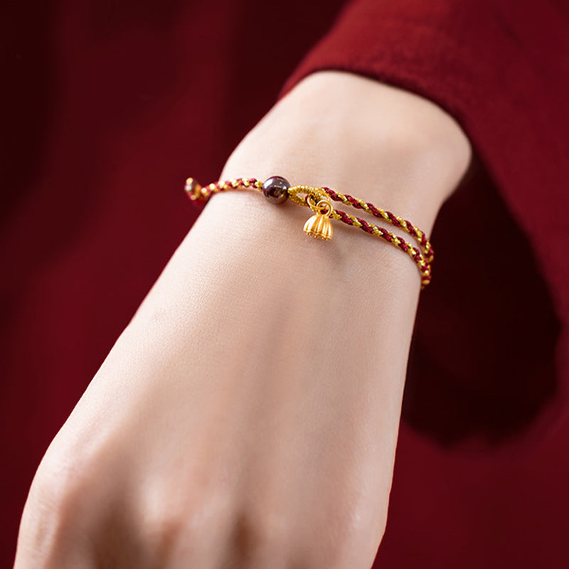 Red Gold Rope Lotus Braid Bracelet - worn on wrist with red sleeve, lifestyle cord bracelet