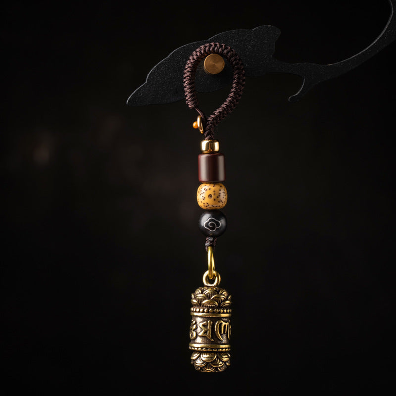 Tibetan Om Mani Padme Hum Brass Car Ornament – B, angled view