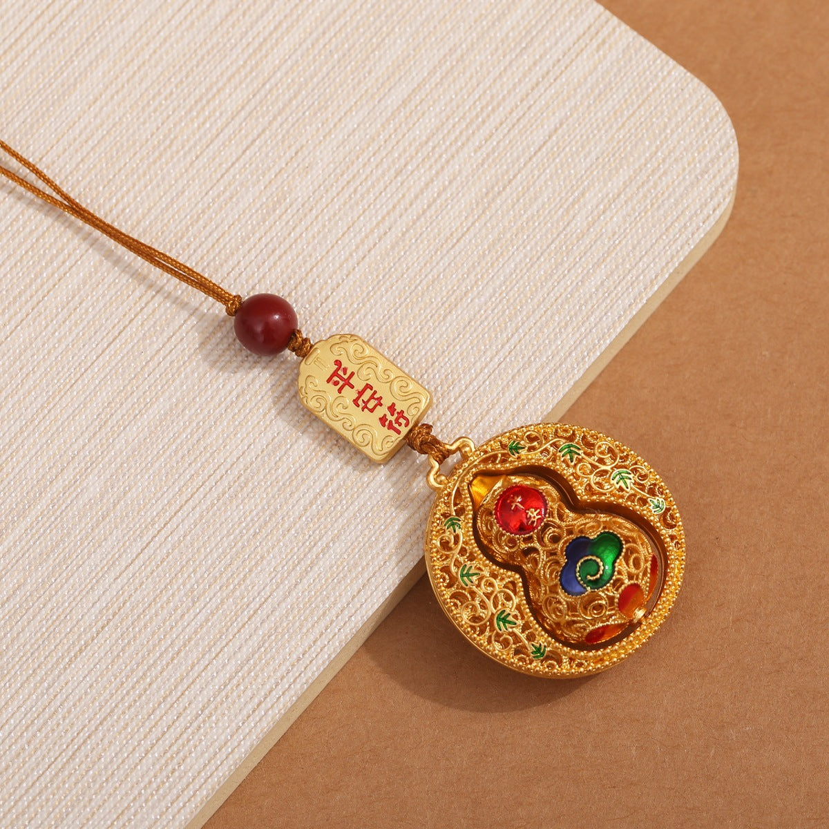 Gold filigree calabash keychain with peace talisman and cinnabar bead, red woven cord