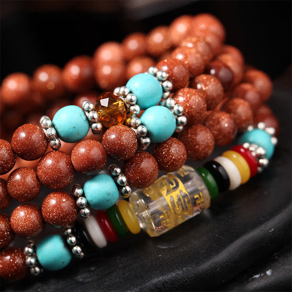 Goldstone Mala Bracelet – coiled bracelet detail with mantra cylinder and color disc beads