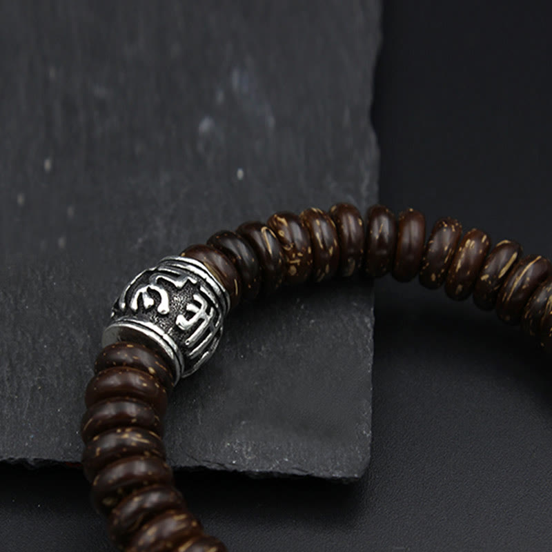 Om Mani Padme Hum Coconut Shell Bracelet – diagonal overhead on dark stone, bead detail