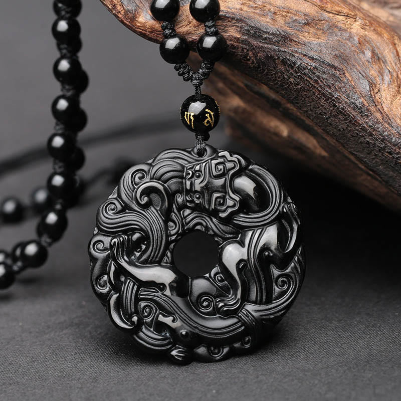 Black Obsidian Pixiu Pendant – Carved black obsidian peace buckle with Pixiu motif, beaded chain