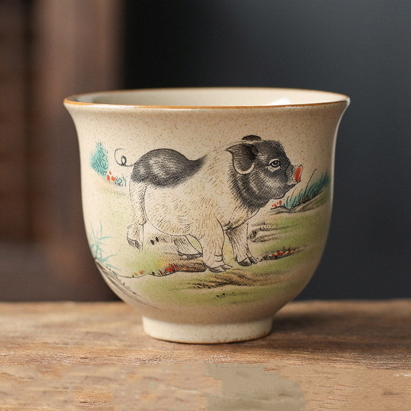 Chinese Zodiac Ceramic Teacup - hand-painted pig zodiac tea cup, speckled clay on wooden surface