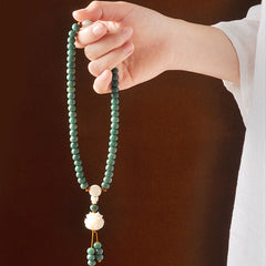 Bodhi Seed Lotus Bracelet – 108-bead mala necklace held in hand with lotus drop, bodhi seed