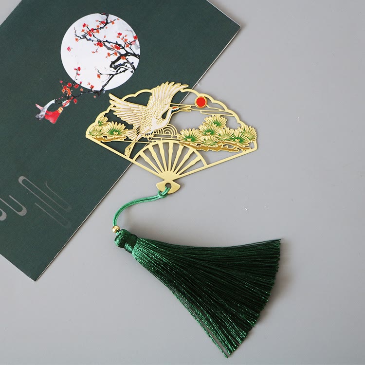 Brass Hollow Fan Bookmark - Detailed cutout design with silk tassel on white book, cultural