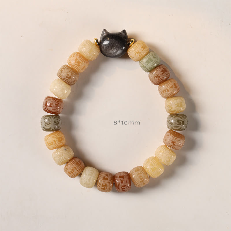 Bodhi Seed Cat Head Bracelet – Top-down flat lay of earth-tone carved beads with dark cat head focal bead, 8x10mm spiritual bead bracelet