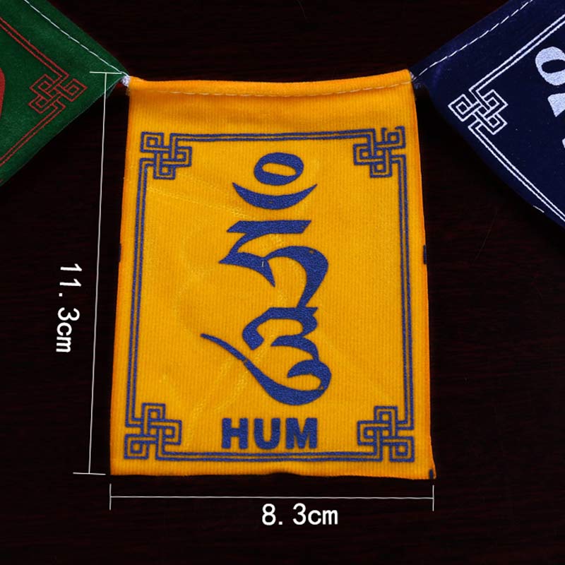 Tibetan Prayer Flags – Single yellow flag top-down on black background showing Tibetan mantra, close-up detail