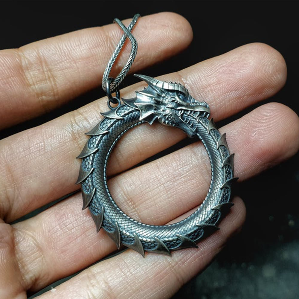 Pure Tin Dragon Snake Necklace - Ouroboros pendant held in hand, intricate scales, guardian jewelry