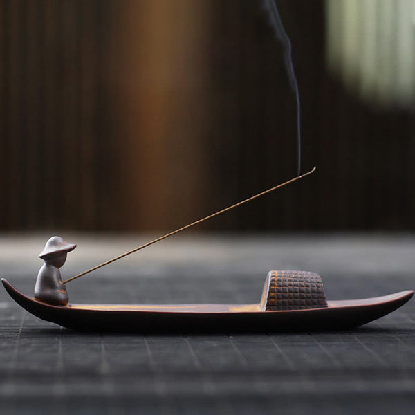 Lonely Fisherman Incense Burner – Boat-shaped ceramic with smoke rising on dark wood, zen art