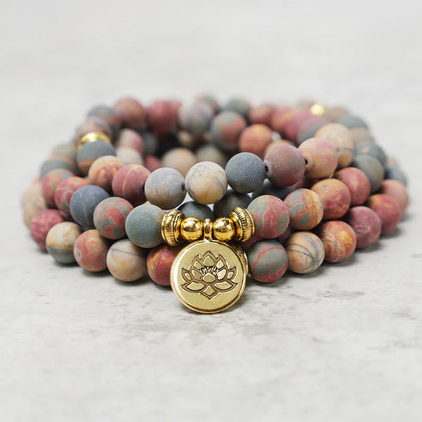 Picasso Jasper 108 Mala Bracelet - stacked coil on marble with gold lotus charm, mala beads