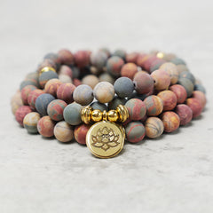 Picasso Jasper 108 Mala Bracelet - stacked coil on marble with gold lotus charm, mala beads