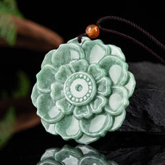 Jade Lotus Pendant Necklace – mottled jade lotus medallion on black reflective surface, Prosperity