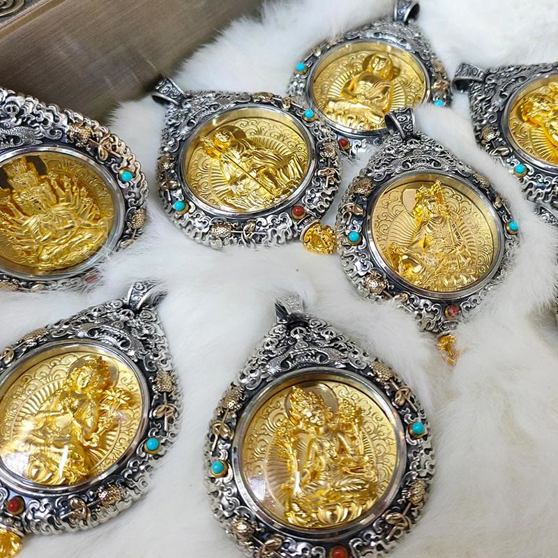 Zodiac Buddha Thangka Wealth Rotatable Pendant – flatlay of multiple pendants on white fur showing variety, collection