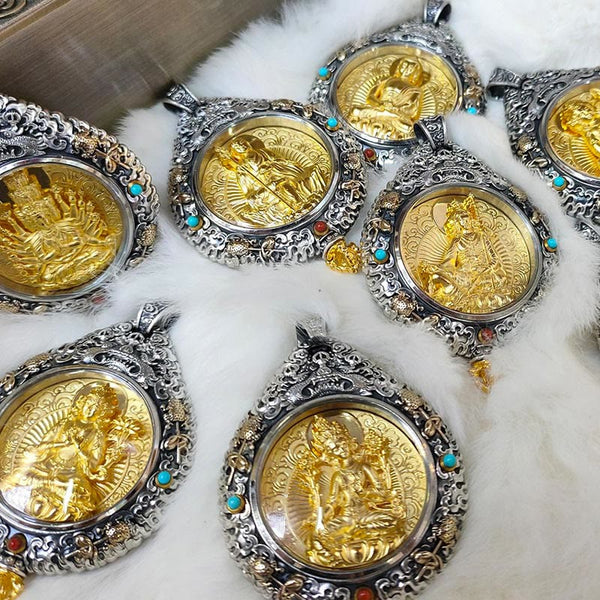 Zodiac Buddha Thangka Wealth Rotatable Pendant – flatlay of multiple pendants on white fur showing variety, collection