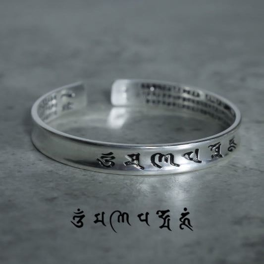 Tibetan Mantra Copper Bracelet - Low angle showing six-syllable mantra on outer band, copper bangle