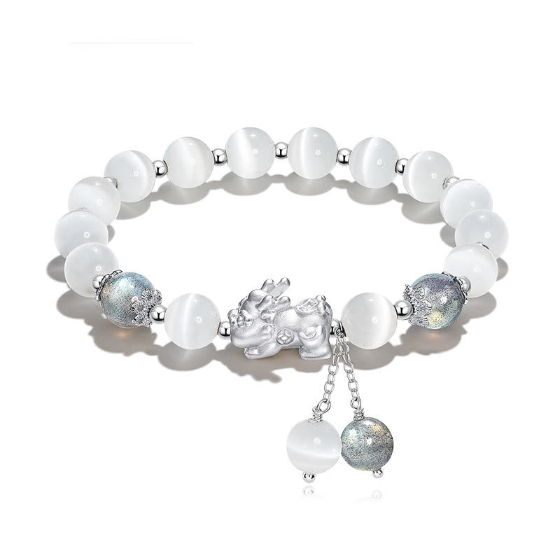 Cat's Eye PiXiu Bracelet – Flat lay on white with cat's eye beads and ornate silver PiXiu centerpiece