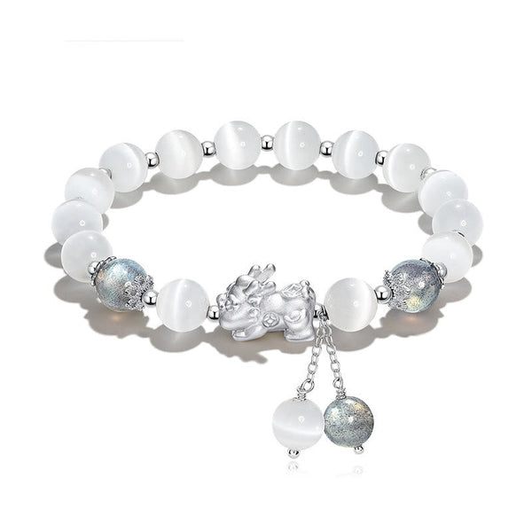Cat's Eye PiXiu Bracelet – Flat lay on white with cat's eye beads and ornate silver PiXiu centerpiece