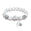 Cat's Eye PiXiu Bracelet – Flat lay on white with cat's eye beads and ornate silver PiXiu centerpiece