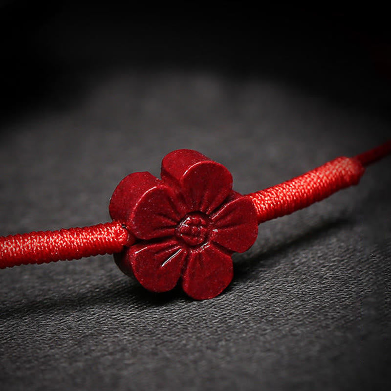 Cinnabar PiXiu Lotus Koi Fish Blessing Braid Bracelet – macro close-up of carved cinnabar flower petal details on red string, blessing bracelet
