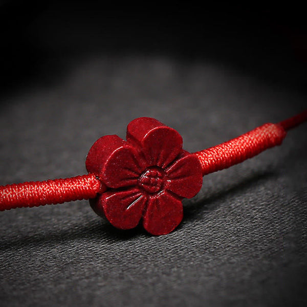 Cinnabar PiXiu Lotus Koi Fish Blessing Braid Bracelet – macro close-up of carved cinnabar flower petal details on red string, blessing bracelet