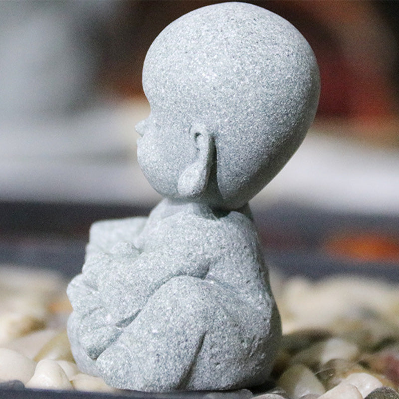 Meditation Monk Statue - Back view of baby monk figurine showing robe details on stones