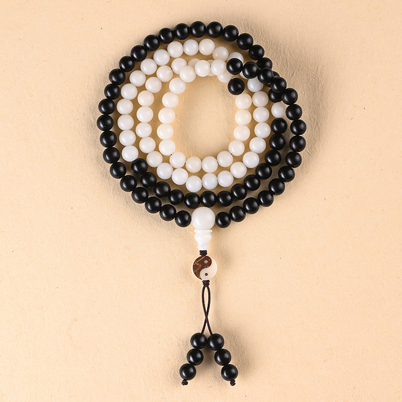 Ebony Yin Yang Protection Mala - 108 bead yin yang mala flat lay with tassel, prayer beads