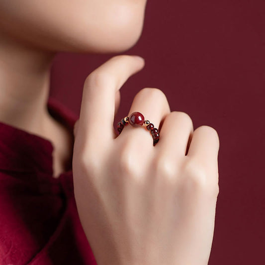 Garnet Cinnabar Ring – model burgundy outfit cinnabar ring finger close up, stylish protection