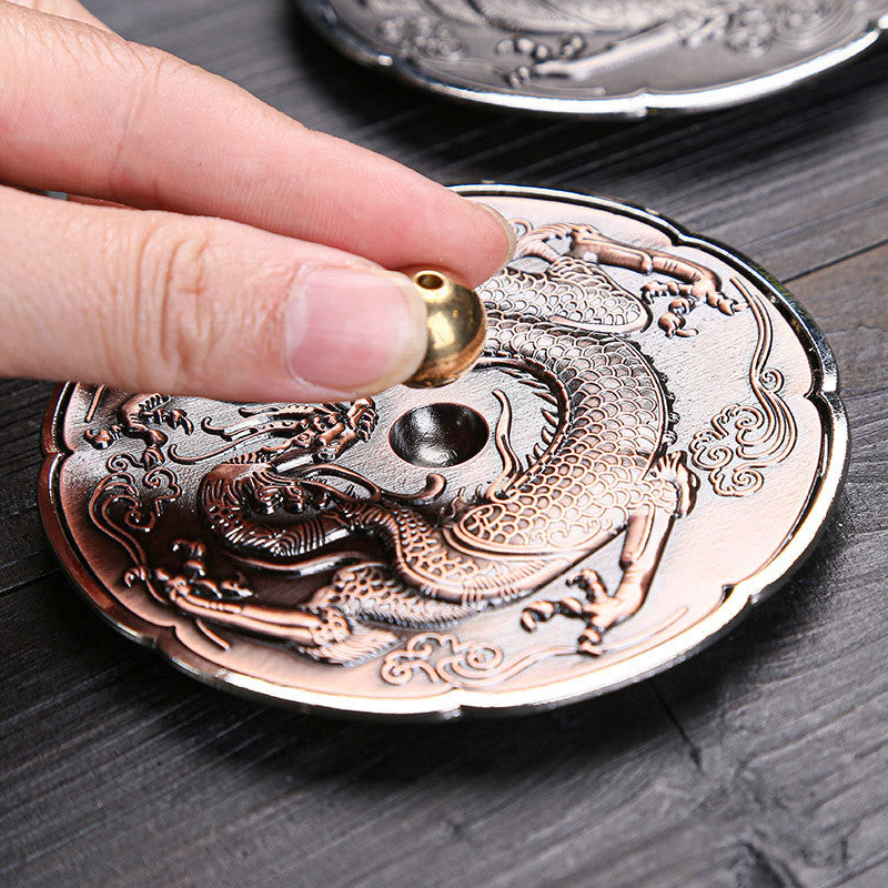 Round Dragon Copper Incense Burner - Close-up placing brass knob into dragon plate, copper finish, zen decor